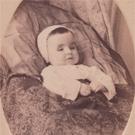 An infant in a baby bonnet 